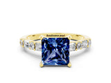 Yellow gold Princess Cut Blue Sapphire Solitaire with Side Baguettes and Channel Set Band