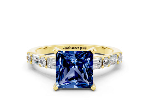 Yellow gold Princess Cut Blue Sapphire Solitaire with Side Baguettes and Channel Set Band