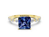Yellow gold Princess Cut Blue Sapphire Solitaire with Side Stones on a Pavé Band and Four-Prong Setting