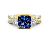 Yellow gold Princess Cut Blue Sapphire Three-Stone Ring with Pavé Split Shank and Four-Prong Setting