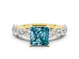 Yellow gold Princess Cut Blue Topaz Prong Setting with Side Stones on a Pave Band