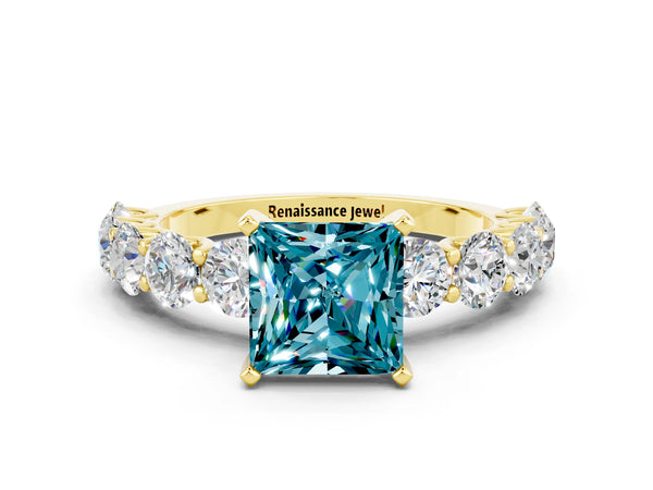 Yellow gold Princess Cut Blue Topaz Prong Setting with Side Stones on a Pave Band
