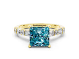 Yellow gold Princess Cut Blue Topaz Solitaire with Side Baguettes and Channel Set Band