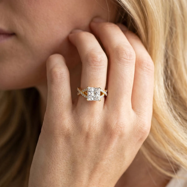 Yellow gold Princess Cut Diamond Solitaire Ring with Four-Prong Setting and Twisted Pavé Band