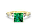 Yellow gold Princess Cut Emerald Solitaire with Side Stones on a Pavé Band and Four-Prong Setting