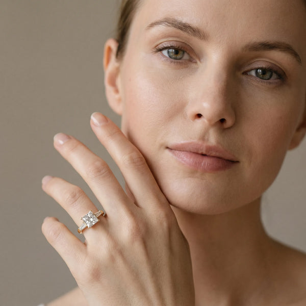 Yellow gold Princess Solitaire with Tapered Baguette Side Stones on a Classic Band with Four-Prong Setting