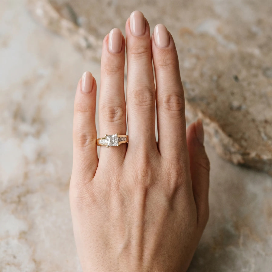 Yellow gold Radiant Cut Channel Set Solitaire Ring with Four-Prong Setting