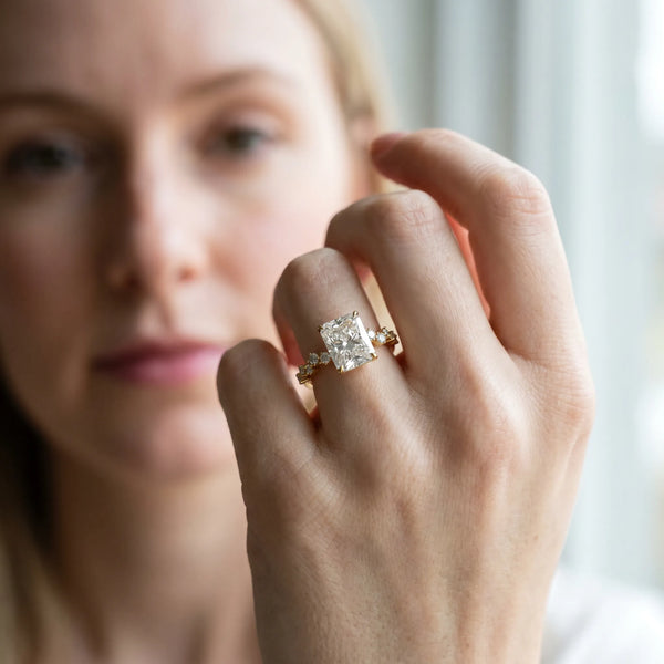 Yellow gold Radiant Cut Diamond Cluster Side Stone Solitaire Ring with Prong Setting