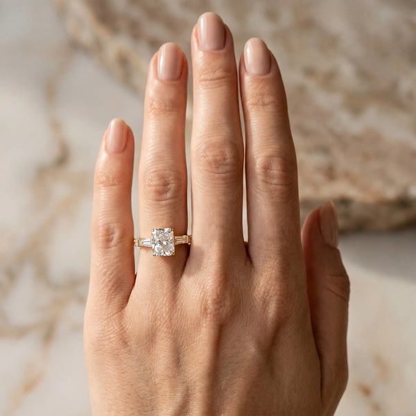 Yellow gold Radiant Cut Diamond Ring with Baguette Side Stones, Channel Set Band, and Four-Prong Setting