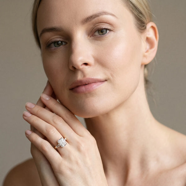 Yellow gold Radiant Cut Diamond Ring with Baguette Side Stones, Channel Set Band, and Four-Prong Setting