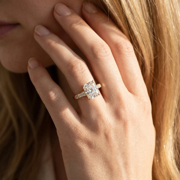 Yellow gold Radiant Cut Diamond Ring with Baguette Side Stones, Channel Set Band, and Four-Prong Setting