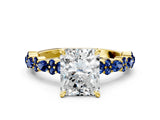 Yellow gold Radiant Cut Diamond Side Stone Solitaire Ring with Round with Blue Sapphire side stone and Four-Prong Setting