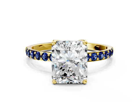 Yellow gold Radiant Cut Diamond Solitaire Engagement Ring with Round with Blue Sapphire side stone Pavé Band and Prong Setting