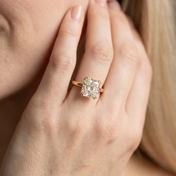 Yellow gold Radiant Cut Diamond Solitaire Ring with Flower Prong Setting and Classic Band