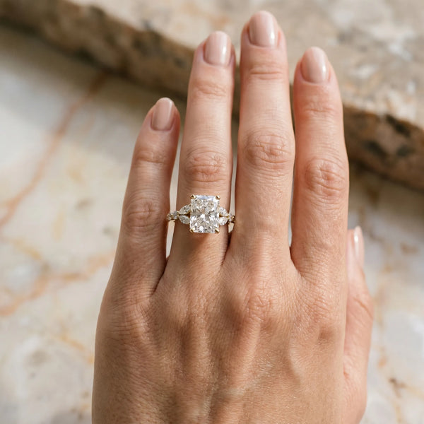 Yellow gold Radiant Cut Diamond Solitaire Ring with Side Stones and Four-Prong Setting