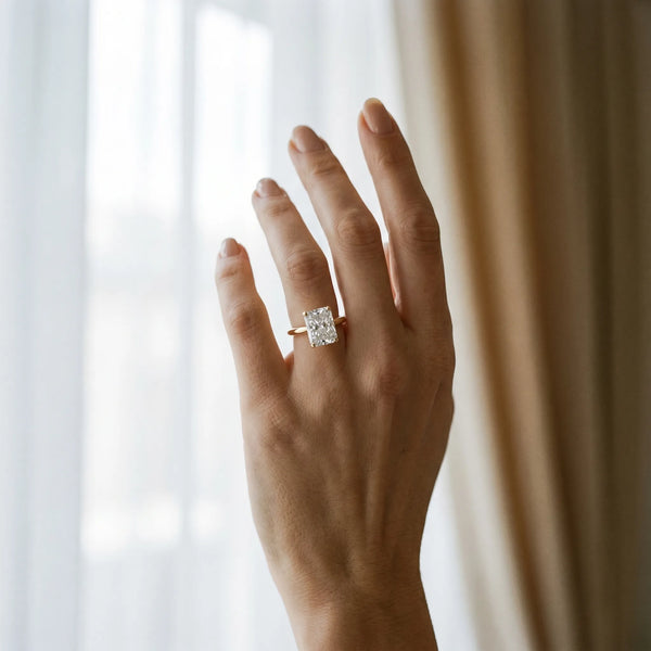 Yellow gold Radiant Cut Diamond Solitaire Ring with Six-Prong Setting and Classic Band