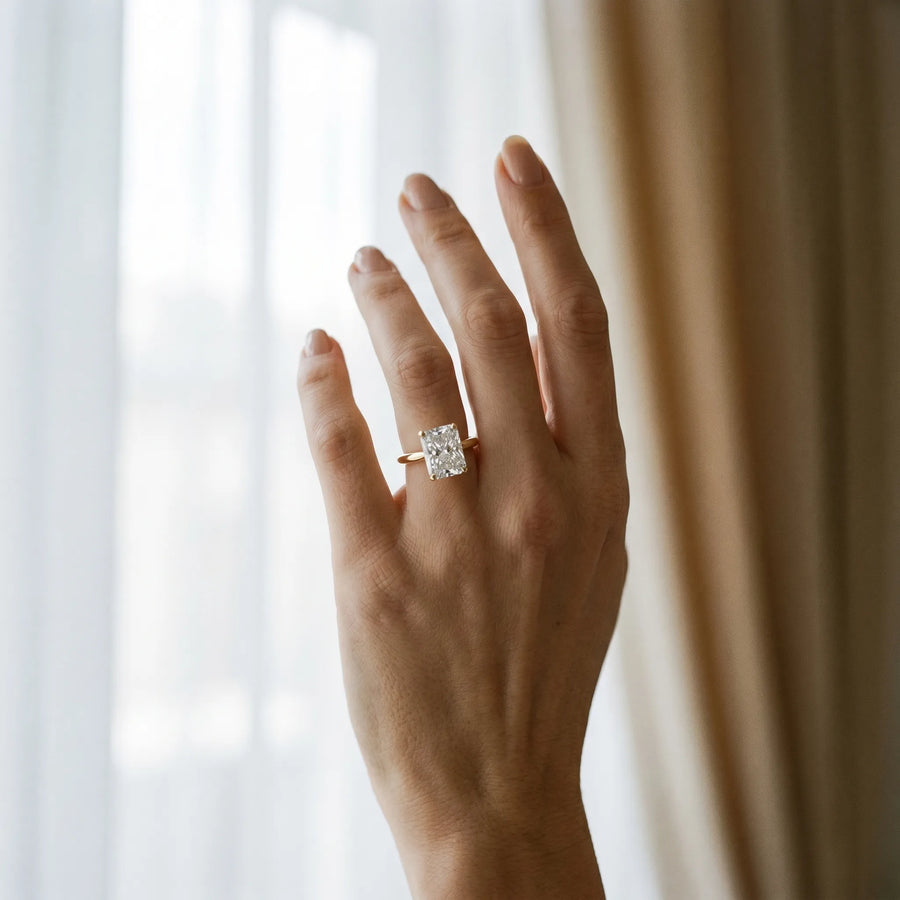 Yellow gold Radiant Cut Diamond Solitaire Ring with Six-Prong Setting and Classic Band