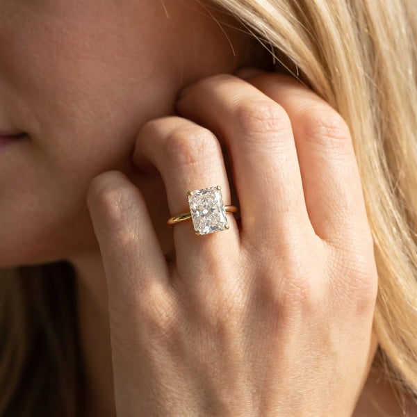 Yellow gold Radiant Cut Diamond Solitaire Ring with Six-Prong Setting and Classic Band