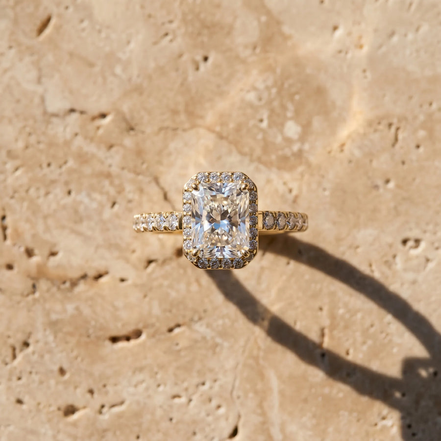 Yellow gold Radiant Cut Halo Diamond Engagement Ring with Pave Band and Four-Prong Setting