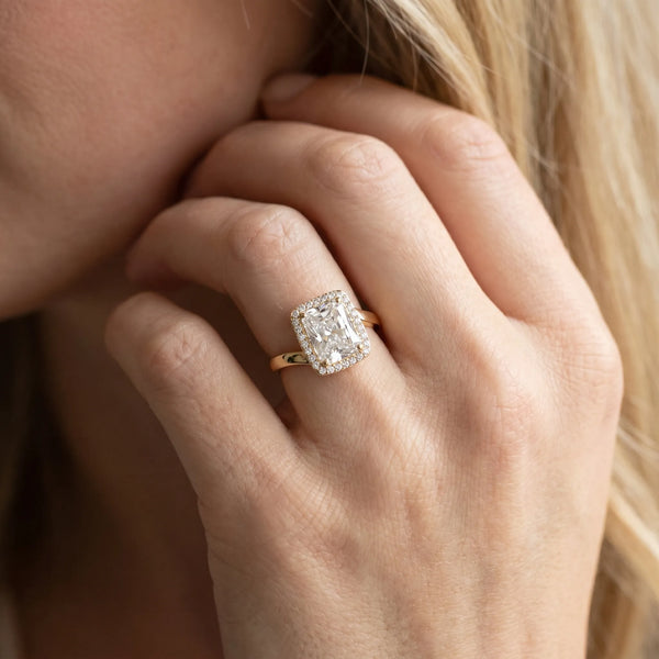 Yellow gold Radiant Cut Halo Solitaire Ring with Channel Band and Four-Prong Setting