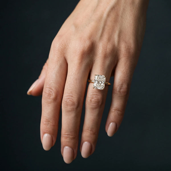 Yellow gold Radiant Cut Solitaire Engagement Ring with Four-Prong Setting and Classic Band