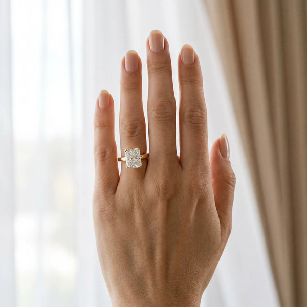 Yellow gold Radiant Cut Solitaire Ring with Four-Prong Setting and Classic Band
