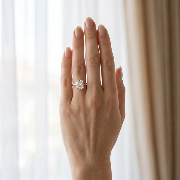 Yellow gold Radiant Cut Solitaire Twist Band Ring with Four-Prong Setting