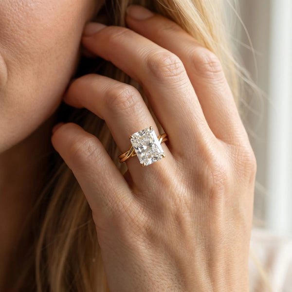 Yellow gold Radiant Cut Solitaire Twist Band Ring with Four-Prong Setting