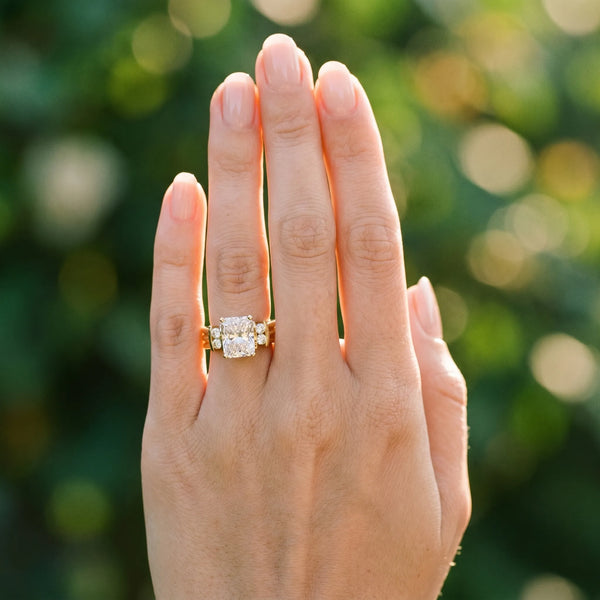 Yellow gold Radiant Cut Three-Stone Channel Set Ring with Bar Prongs