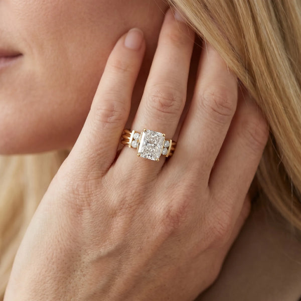 Yellow gold Radiant Cut Three-Stone Channel Set Ring with Bar Prongs