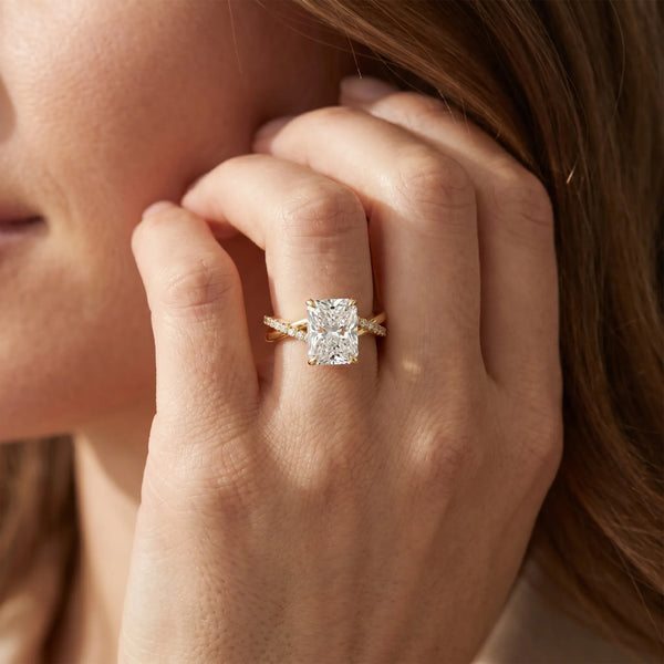 Yellow gold Radiant Cut Twist Band Solitaire Diamond Ring with Pavé Setting