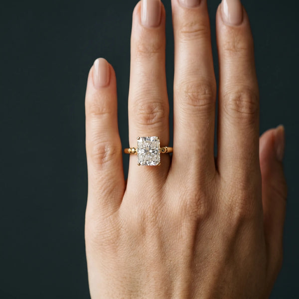 Yellow gold Radiant Solitaire Beaded Band with Four-Prong Setting