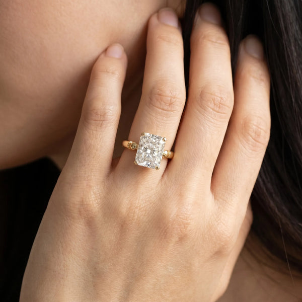 Yellow gold Radiant Solitaire Beaded Band with Four-Prong Setting