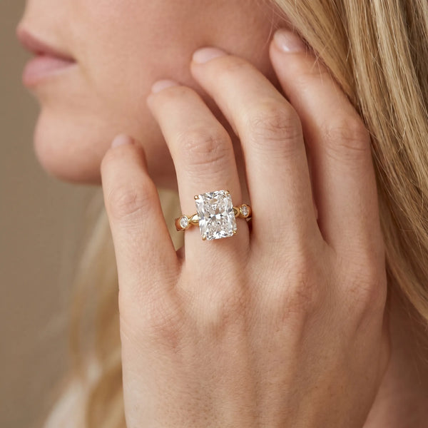 Yellow gold Radiant Solitaire Bezel-Set Diamond Ring with Beaded Band and Four-Prong Setting