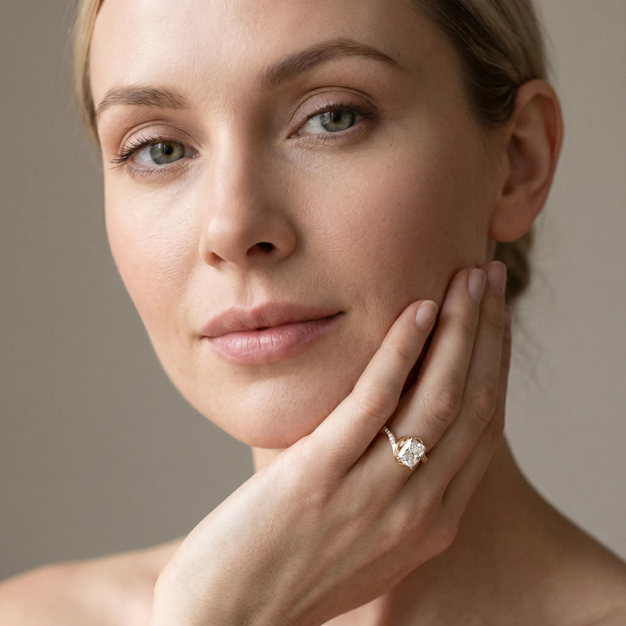 Yellow gold Radiant Solitaire Twist Band with Channel-Set Diamonds and Four-Prong Setting
