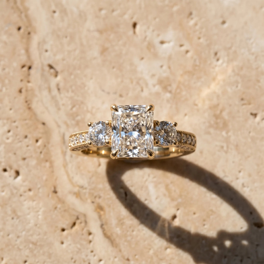 Yellow gold Radiant Three-Stone Diamond Ring with Pavé Band and Four-Prong Setting