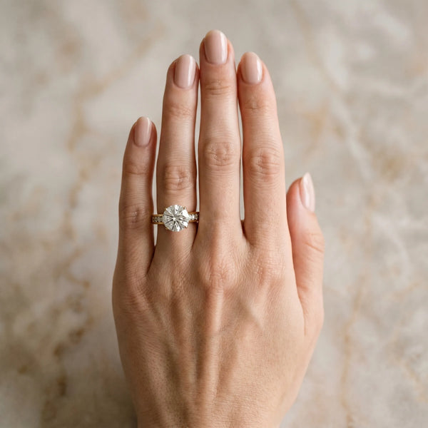 Yellow gold Round Brilliant Channel-Set Solitaire Ring with Four-Prong Setting