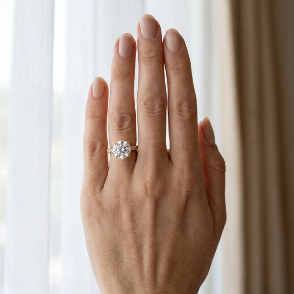 Yellow gold Round Brilliant Diamond Solitaire with Pavé Band and Four-Prong Setting