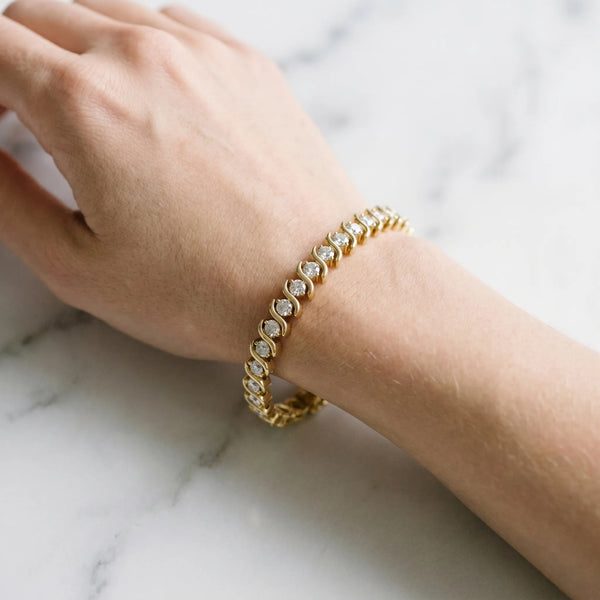Yellow gold Round Brilliant Diamond Tennis Bracelet with Channel Set S-Shaped Prong Setting