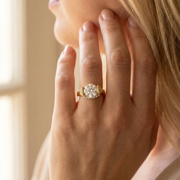 Yellow gold Round Brilliant Solitaire Diamond Ring with Channel Set Band and Bar Prong Setting
