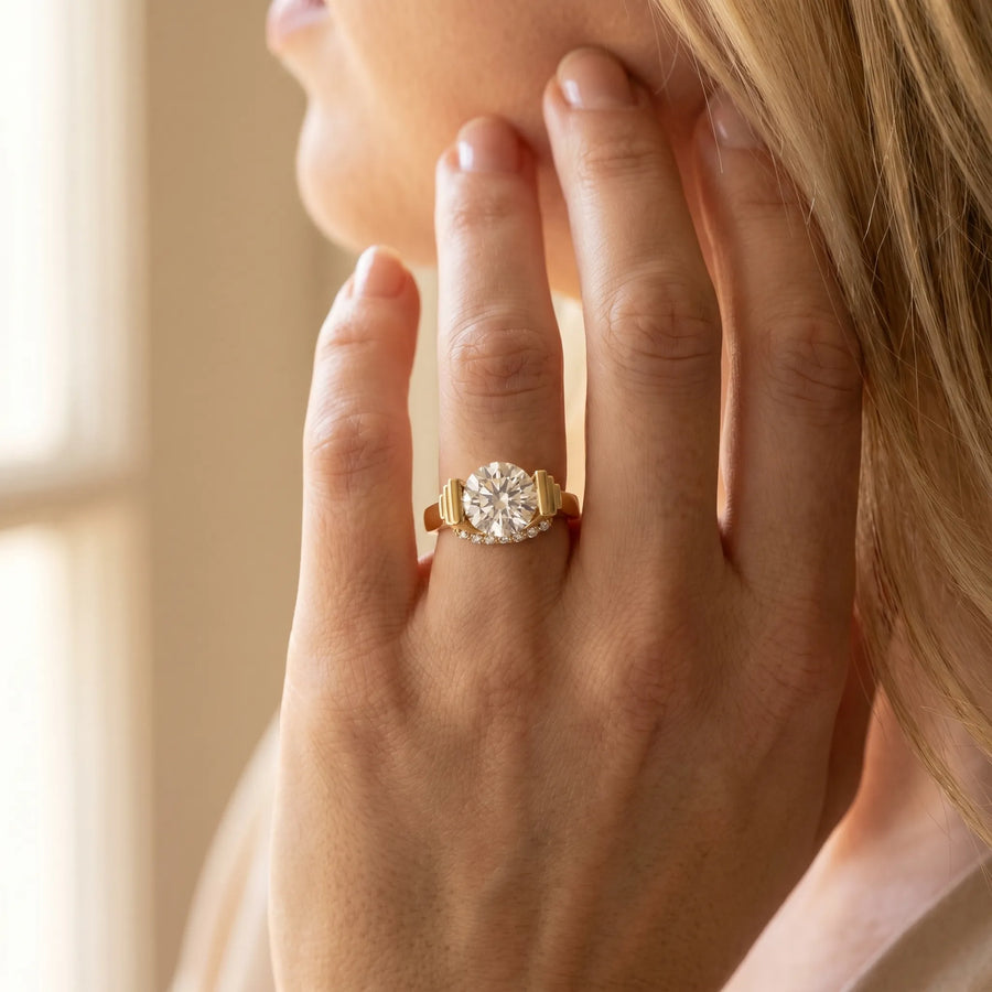 Yellow gold Round Brilliant Solitaire Diamond Ring with Channel Set Band and Bar Prong Setting