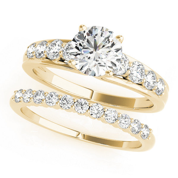 Yellow gold Round Brilliant Solitaire with Side Stones on a Pave Band and Four-Prong Setting