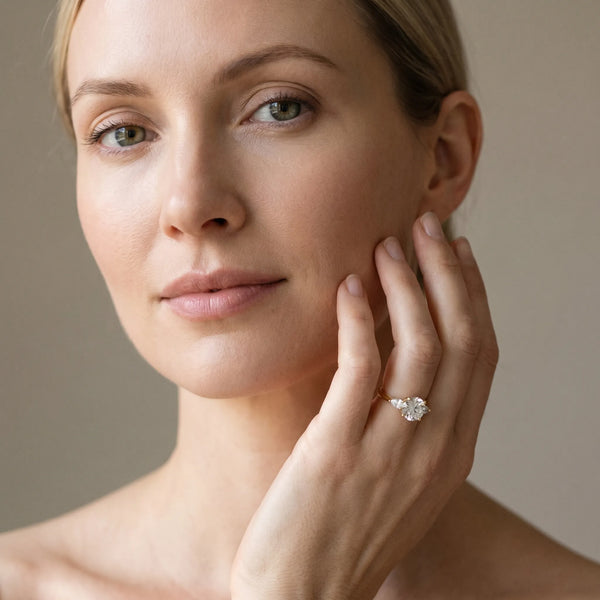Yellow gold Round Brilliant Three-Stone Ring with Pear Side Stones and Four-Prong Setting