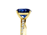 Yellow gold Round Cut Blue Sapphire Engagement Ring with Side Stone Accents and Four-Prong Setting_65
