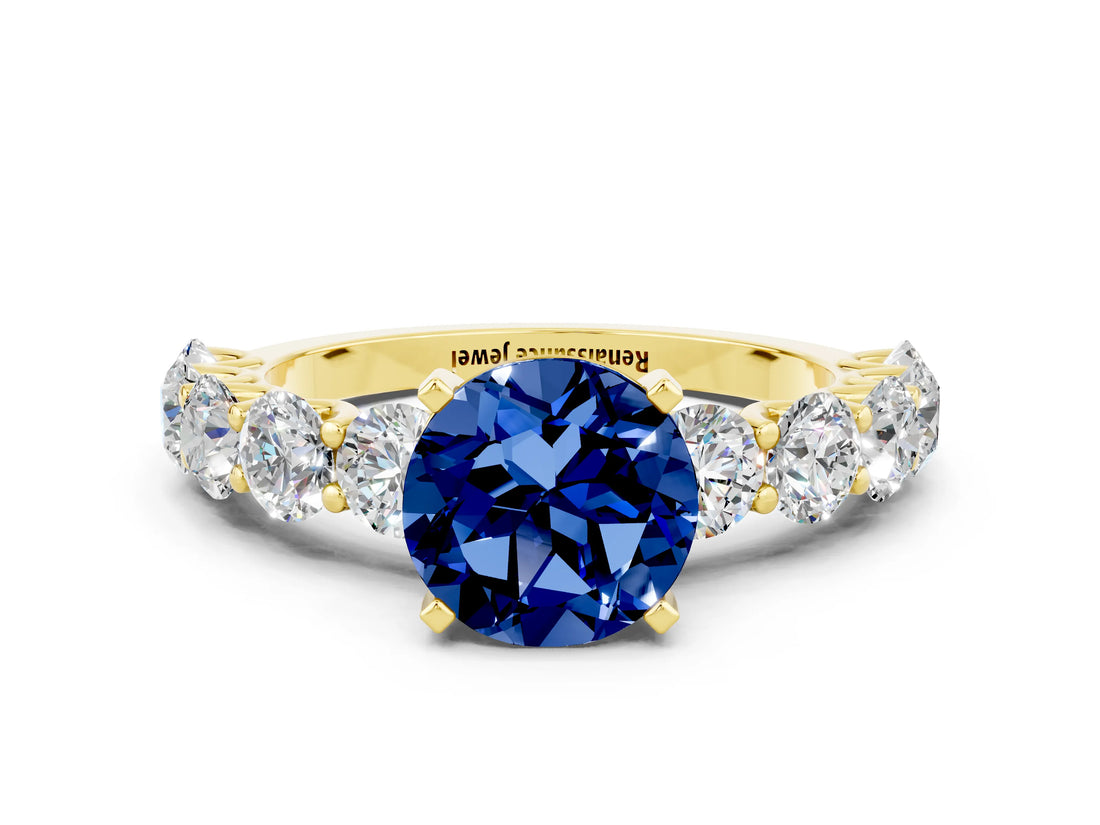 Yellow gold Round Cut Blue Sapphire Prong Setting with Side Stones on a Pave Band