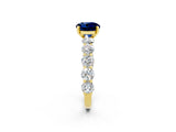 Yellow gold Round Cut Blue Sapphire Prong Setting with Side Stones on a Pave Band_2
