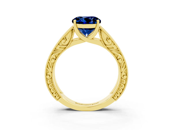 Yellow gold Round Cut Blue Sapphire Solitaire Ring with Engraved Band and Four-Prong Setting