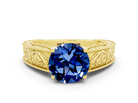 Yellow gold Round Cut Blue Sapphire Solitaire Ring with Engraved Band and Four-Prong Setting