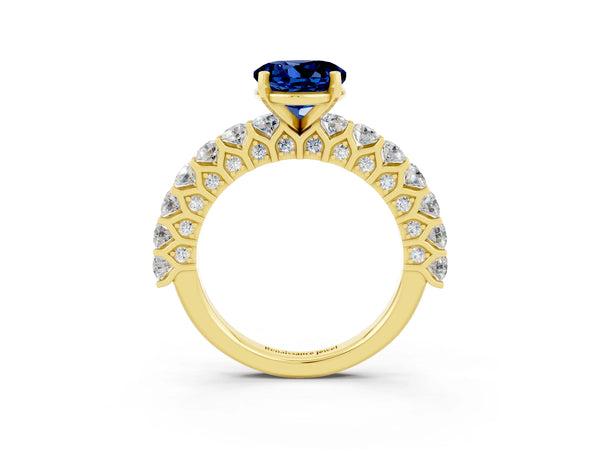 Yellow gold Round Cut Blue Sapphire Solitaire Ring with Shared Prong Pavé Band and Four-Prong Setting