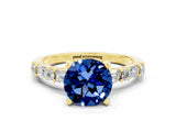 Yellow gold Round Cut Blue Sapphire Solitaire with Side Baguettes and Channel Set Band